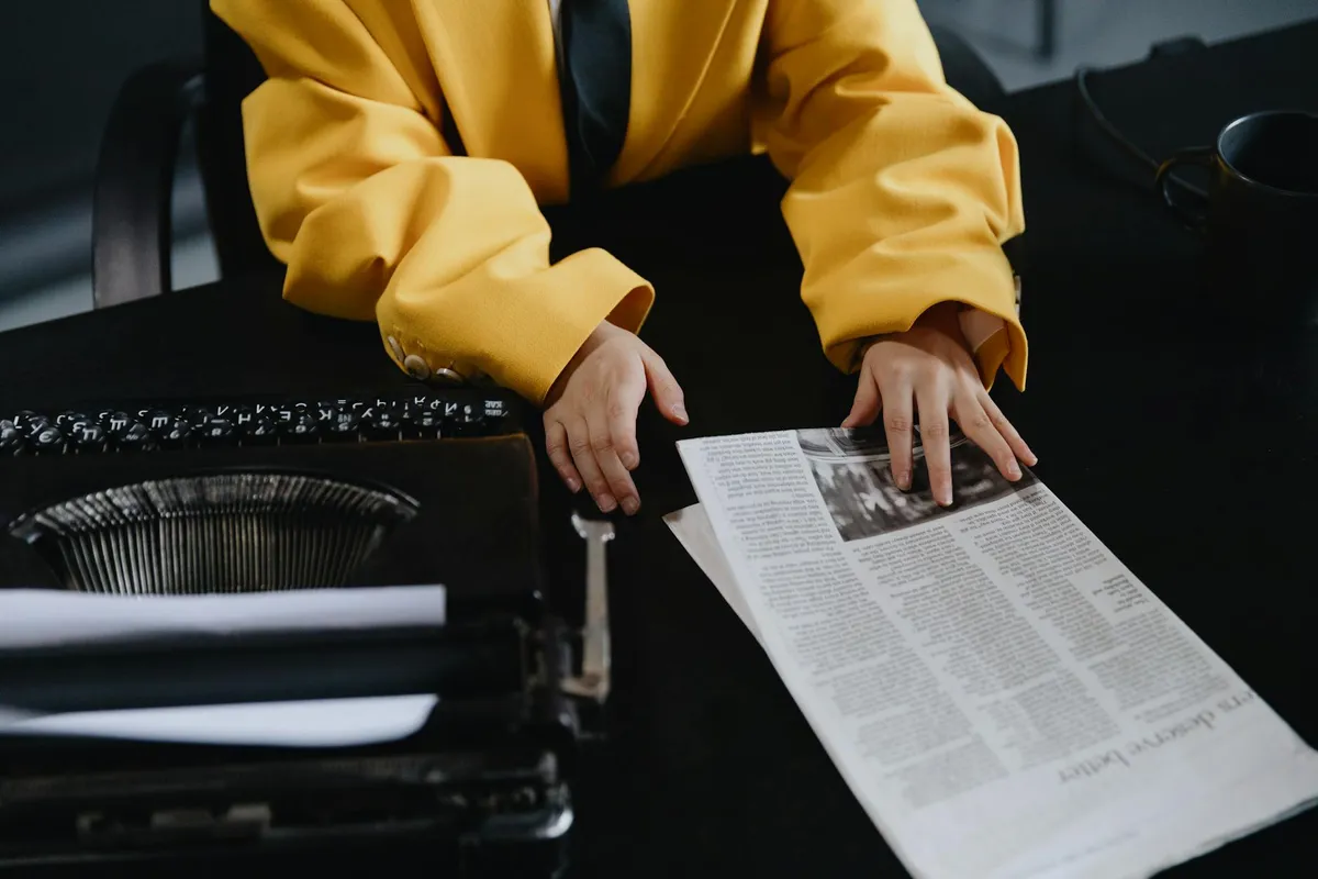 A quirky news desk with vintage typewriter and modern accessories